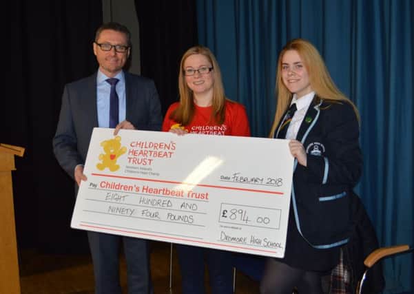 Principal Mr McConaghy and Cory Scott (year 13) pupil from Dromore High School present a cheque for Â£894.00 to Mrs Lynn Cowan from Childrens Heartbeat Trust. The money was raised at the Music Departments Christmas by Candlelight Service held at Dromore Cathedral in December.