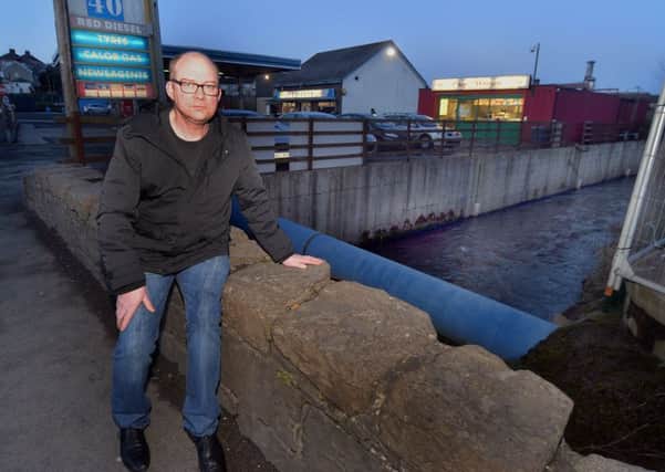 Councillor Paul Duffy pictured at the low bridge wall over the Corcrain River which he believes is a safety risk and has a theory that Norrman Prentice whose body was found further along the river in Portadown People's Park last week may have fallen into the river from the bridge. Norman lived directly opposite the bridge and could often be seen sitting on it. INPT07-206.