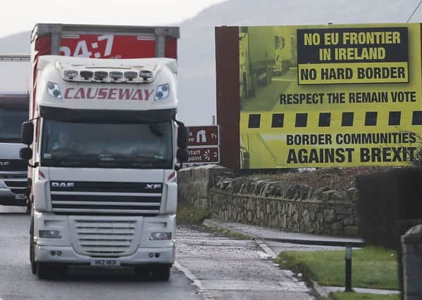 A truck passes a Brexit billboard in Jonesborough, Co. Armagh, on the northern side of the border between Northern Ireland and the Republic of Ireland. Photo by Niall Carson/PA Wire