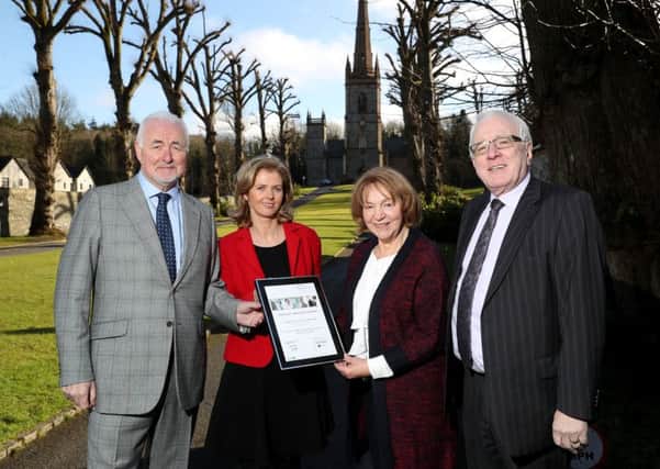 Tourism NI Chairman Terence Brannigan (left) joins People 1st Director Roisin McKee (second from left) in presenting Lyn Barton, owner of Coach House Hillsborough, with a plaque to mark her becoming the 20,000th person trained through the WorldHost customer service campaign. They are pictured with Alderman Allan Ewart MBE, Chairman of the councils Development Committee.