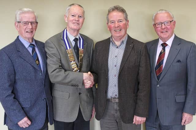Coleraine Probus President Des Moore greets Michael Moss, with club Treasurer Nigel Semple (L) and club member Norman Gallagher (R).