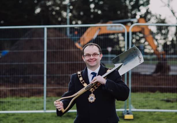 Mayor, Councillor Paul Hamill cuts the sod at Antrim Lough Shore Park to mark the commencement of work on the new play park