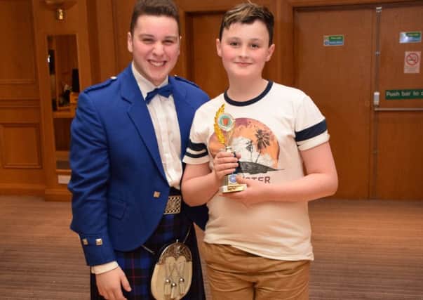 Jayden Elliott, Larne, who won the 12 & Under  Sacred Solo and the Preliminary Sections receiving his prize from special guest Brandon McPhee at the NI Open Accordion Championships in Carrick.