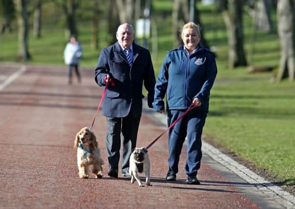 Chairman of Lisburn and Castlereagh City Council's Environmental Services Committee, Alderman Tommy Jeffers and Enforcement Officer, Joanne Macaskill are pictured in Wallace Park promoting responsible dog ownership.