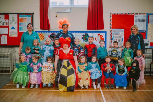 Asda Portadown Community Champion, Elaine Livingstone, joins (back row, L-R) Paula Whitla (Epworth Playgroup Support Worker), Stephanie Cardwell (Epworth Playgroup Deputy Playgroup Leader) and Epworth Playgroup Leader, Janice Adams with the children from Epworth Playgroup celebrating World Book Day.