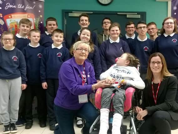 Brooke with Roma Brown, NI Childrens Hospice; Alison McClean from Forever Living, and students from Roddensvale School Choir.