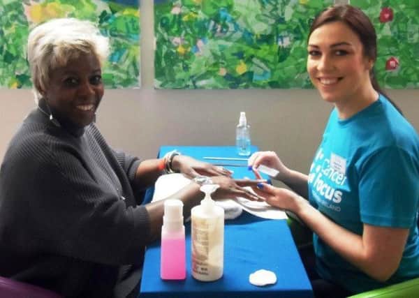 Cancer patient Denise Patrick, left, enjoys a nail treatment from Cancer Focus NI volunteer beautician Natalie Thompson while she waits for a hospital appointment. Nails can be badly affected by chemotherapy. The charity is appealing for more NVQ level 2 volunteers to help at its nail bar at Belfast City Hospital.