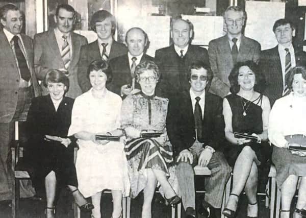 Awards to mark ten years of service were presented to Bridgeport Brass staff in 1980. Pictued are Mrs McKeown, Mrs Gilliland, Mrs Bell, Mrs Boyd, Miss Williamson, Mrs Woods, Mr Boyle, Mr Poots,  Mr McClenaghan, Mr Morgan, Mr Muldoon, and Mr Russell. The presentations were made by Mr F Mitchell, personnel manager. Also pictured are Mr Ward, technical manager and Mr Massey, chief accountant.