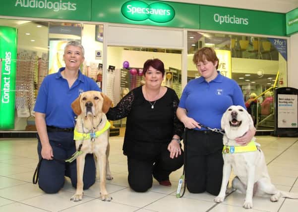 Guide dog owners Diane Marks (left) with Morris and Andrea Hope with her dog Debbie are pictured with Siobhan McGoldrick (centre) store director at Specsavers Abbeycentre.