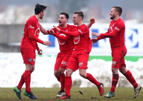 Loughgall's Dale Montgomery celebrates scoring with team mates
