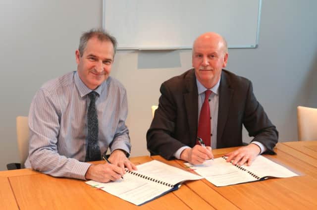 David Small of the Northern Ireland Environment Agency and Stan Brown of Forensic Science Northern Ireland sign a Memorandum of Understanding.