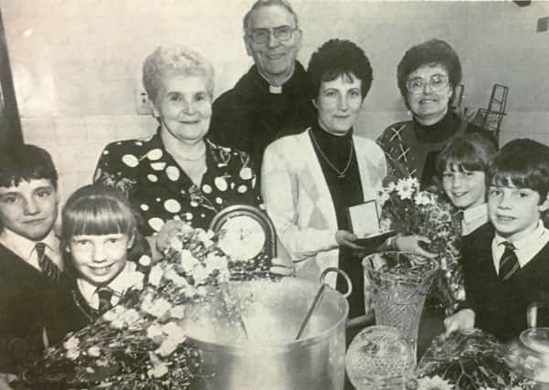 The cook at St Colman's Primary School Dromore Mrs D McGuigan (third left) retired in 1992 after 20 years at the school and caretaker Mrs Christine McAleenan (fourth right) left after 12 years. They are pictured with James Crory, CIara Cullens, Father PG Conway, Rosemary Mulgrew, Catrina McAteer and Wayne Hutchinson