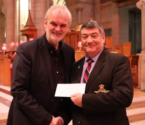 Wg Cdr Noel Williams collects Â£550 for  RAFA from comedian Tim McGarry.