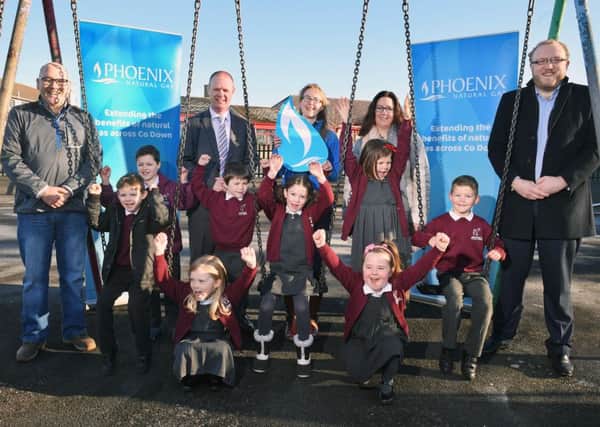 Pictured celebrating the news is Principal Richard Reid, Karen White from Phoenix Natural Gas with members of the Anahilt Primary School Parent Teacher Association and school pupils.