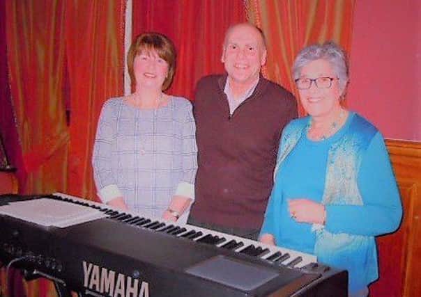 Jane and Brian Hill who entertained Muckamore WI members with a medley of songs at their March meeting and dinner, pictured with Jennifer Johnston who presented them with a gift and proposed the vote of thanks