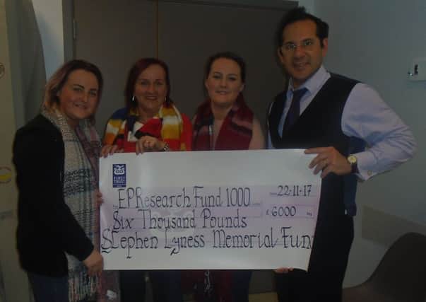 The Lyness family present a cheque for Â£6,000 for SADS research.