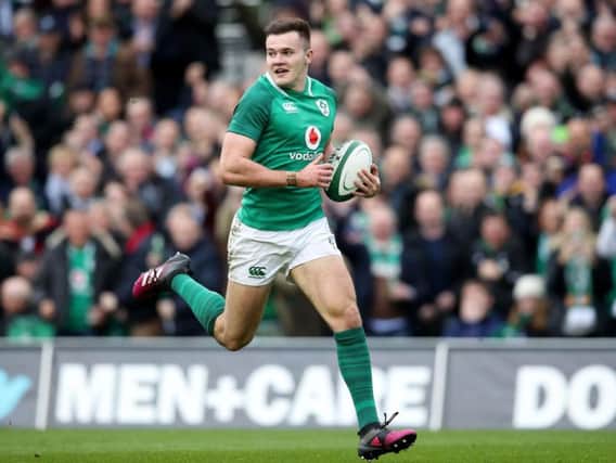 Jacob Stockdale scores the first of two tries against Scotland