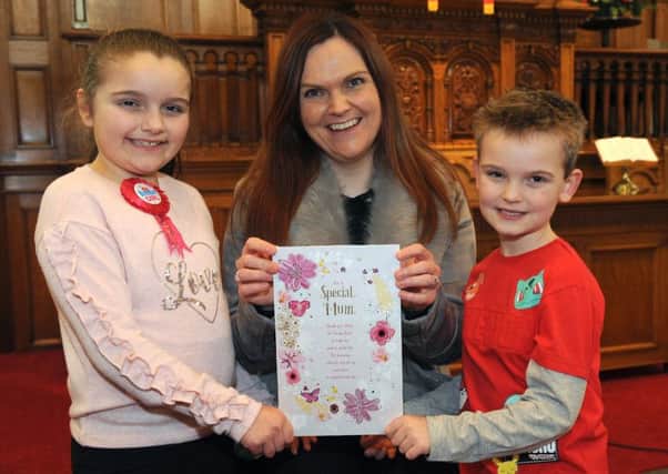 Special Mum:  Alanah and Adam Houston pictured presenting a Mothers Day card to their Special Mum Kerry at the Mothers Day Service in Railway Street Presbyterian Church, Lisburn on Sunday 11th March.  It was a triple celebration for the Houston family because in addition to celebrating Mothers Day Alanah was celebrating her ninth birthday and Adam celebrated his seventh birthday the previous day, Saturday 10th March.
