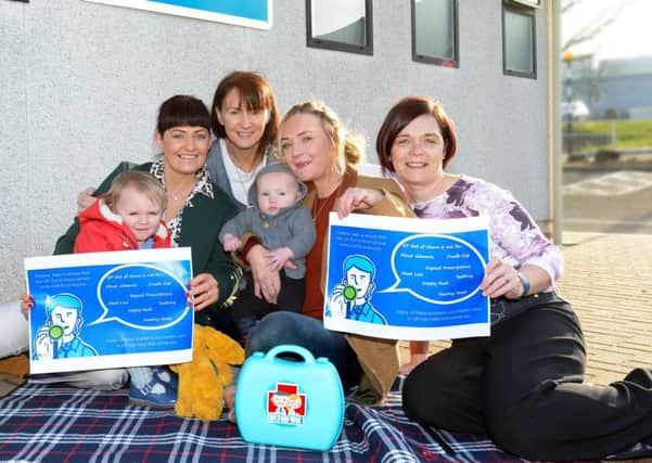 Raising awareness: Health Visitor Clare Walsh, Health Visiting Manager Deirdre Ward and Cathrine Reid, Head of Service for GP Out of Hours, with Emma Murtagh and her children Pippa and Henry.