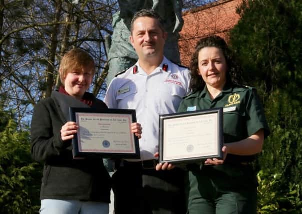 Chief Fire and Rescue Officer Gary Thompson formally commended and presented Certificates of Bravery on behalf of the Society for the Protection of Life from Fire to Amanda White (left) and paramedic Tara Wallace for their rescue of a woman from a house fire in Annahilt.