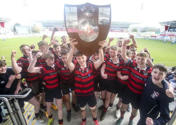 l

Ballymena Academy captain Adam Lamont and his team celebrate winning the 2018 Medallion Shield Final against Campbell College at Kingspan Stadium