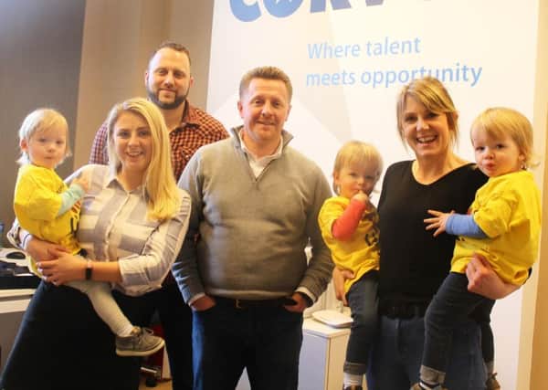 Alex Devenney (Marketing Executive), holding Edie, Gareth Stirling
(Senior Web Development and UX/UI Recruiter), Diarmaid Robinson (Senior Mechanical and Electrical Recruiter) and Lesley Armstrong (Office Manager) holding Danny and Luka.
