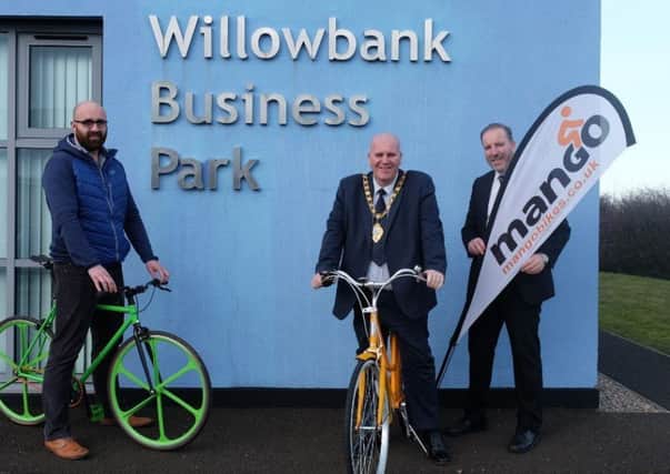 Mid and East Antrim mayor Cllr Paul Reid visited Andrew Hassard (left) of Mango Bikes at Willowbank Business Park. Included is LEDCOM chief executive Ken Nelson.