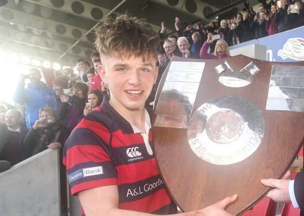 Ballymena Academy captain Adam Lamont receives the Medallion Shield from Ulster Branch President Graffin Parke after his side won the 2018 Medallion Shield Final between Campbell College and Ballymena Academy at Kingspan Stadium