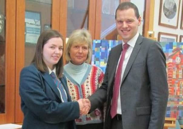 Banbridge Academy student Arlene Rowan is congratulated  by principal Robin McLoughlin on her recent success in two national competitions as Aileen Gilpin, Head of Careers, looks on.