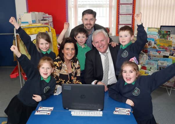 Local resident Gordon Symington, School Principal Fiona Hampsey, and Head of Wholesale Sales & Marketing, Frank McManus, with pupils from Clintyclay Primary School in Dungannon celebrating the signing of Northern Irelands first Community Fibre Partnership. Pupils (left to right): Saule Dieckute, Cadhla McCann, James McGeown, Matthew Duggan and Clodagh ONeill).
