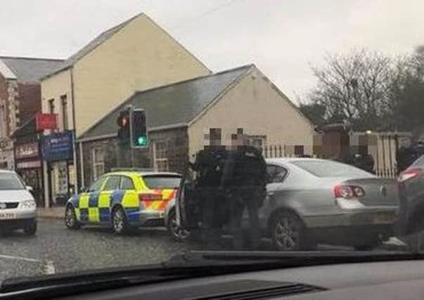 Police officers pictured on Main Street in Ballyclare on Friday, March 16.