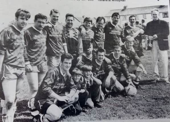 Bushmills who won the Times Division Championship in June 1993. Presenting the cup and medals is editor David Rankin.