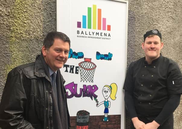 Chairman of Ballymena BID, Andrew Storey is pictured with Kenny Wright from McAtamneys Butchers and one of the winning designs from the Keep Ballymena Safer, Cleaner and Accessible Poster Campaign.