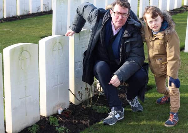 Gavin McAlinden with his son Shay at the grave of Private James Furphy