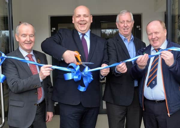 John Ball from the Department For Communities, cut the ribbon to officially open the new Clan Na Gael GAC clubrooms on Tuesday Morning. Also included are from left, Michael Hasson, president of the Ulster GAA Council, Noel O'Hagan, chairman, Clan Na Gael, and Michael Savage, Armagh County chairman. INLM13-201.