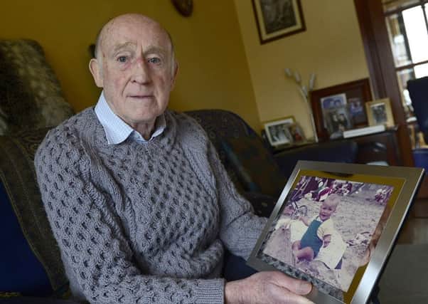 Jackie Nicholl holds a photo of his 17 month old son, Colin, who was killed by an IRA bomb. He has just resigned from the Victims Forum after disovering a convicted IRA bomber is a fellow member.
 Photo: Arthur Allison/Pacemaker.