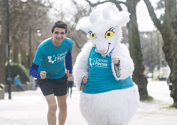 Lisburn dad Ollie Govett training for the London Marathon with Genevieve the Goat, the Cancer Focus Northern Ireland mascot.