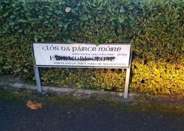 The vandalised street sign in Parkmore Close.