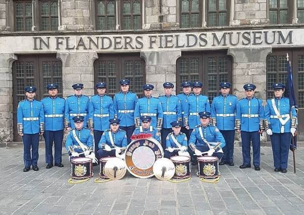 Members of Lambeg Orange and Blue Flute Band outside In Flanders Fields Museum in Ypres, Belgium.