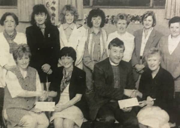 Seapatrick Parish young wives group had over cheques to Crossroads Care co-ordinator Mary Hutchinson and Rev John Scott.