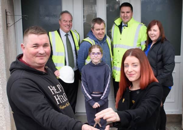Pictured receiving the keys to the new family home from Charlene Norrell ( Housing Executive Patch Manager) is  Mr Sammy McKay along with his daughter Jessica McKay. Also pictured is  Gerry McEvoy (Mascott Construction), Carol O'Kane ( Housing Executive Schemes Manager) Aidan Darragh (Site Foreman) and  Arden Pollock (JCP Consulting).