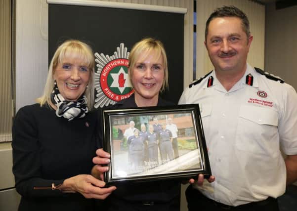 Trainee Firefighter Control Operator from Ballymena, Wendy Shaw celebrates her graduation with Carmel McKinney, OBE, NIFRS Chairperson and Gary Thompson, Chief Fire & Rescue Officer.
