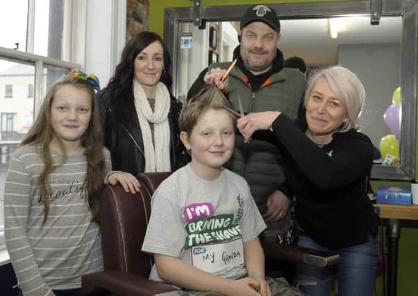 Dromore Central pupil Tyler Whitten "Braved The Shave" for his Granda in aid of Macmillan Cancer Support, ready for the first cut is Cheryl of The B-Hive Barber in Dromore, included is Tyler's Dad Colin, Mum Lyndsey and sister Kayla Â©Edward Byrne Photography INBL1814-201EB