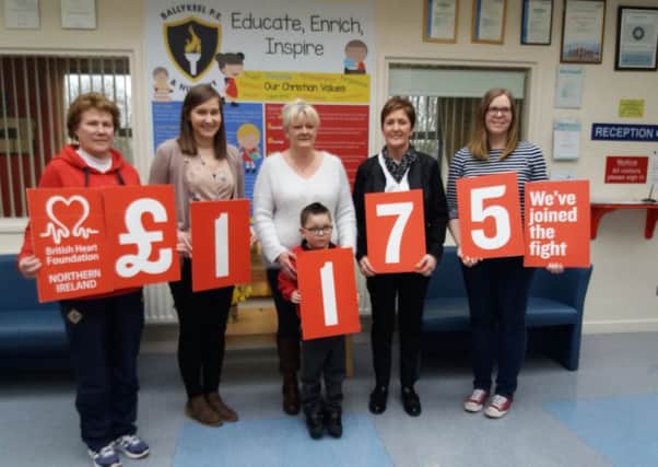 Ballykeel PS pupil Mark Lynn with his teachers and mum Donna handing over Â£1,175 to British Heart Foundation NI.
