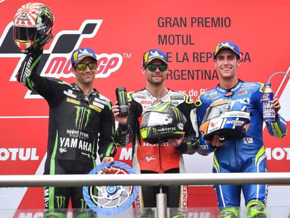 Cal Crutchlow celebrates his victory in Argentina with Johann Zarco and Alex Rins.