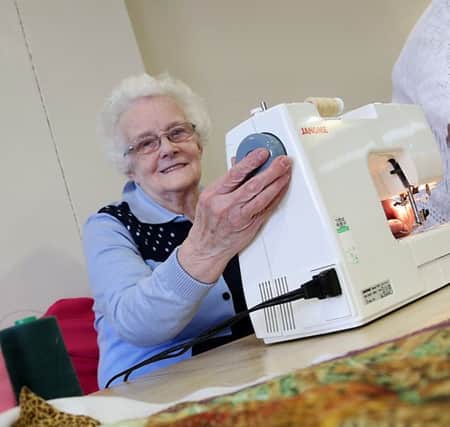 One of the Crafts With Love participants sews cushion covers.
