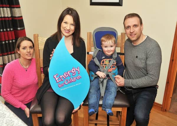 Energy for Children Charity Liaison Officer, Geri Wright congratulates Dara Walls (3) and his family on receiving a specialist seat from the Energy for Children Charitable Trust.