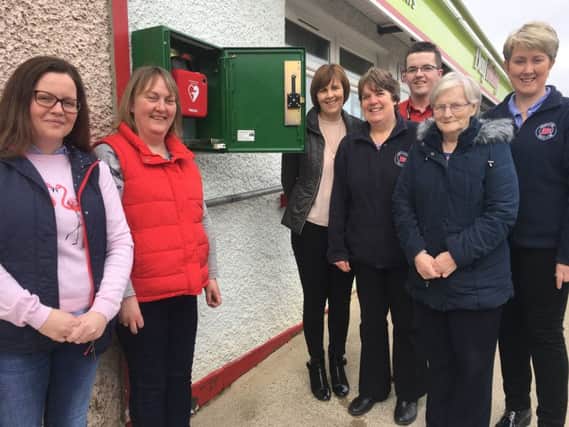 Pictured at the site of the defibrillator are members of the Watt family - Daisy, Rachel and Kathleen, Rosemary Devine Manager of Dennett Interchange, Margaret McLaughlin Chairperson of The Drummond Centre Project Ltd, David Buchanan Director of The Drummond Centre Porject Ltd and Pearl Smyth Director of The Drummond Centre Project Ltd.