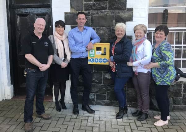 Checking out the new defibrillator in Coagh are Les Ross (Tamlaght), Carmel Lyttle (Stewartstown Health Centre) and members of the Curran family.