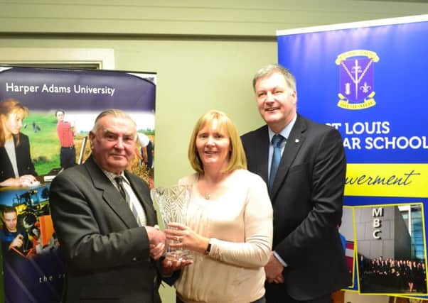 Basil Bayne of Harper Adams in Ireland presents a crystal vase to Ms Louise Gildea, Head of Geography and Agriculture teacher at St Louis Grammar as a perpetual award to recognise achievement on the BTEC Agriculture course offered at the school. Included, Sean Rafferty, Principal.